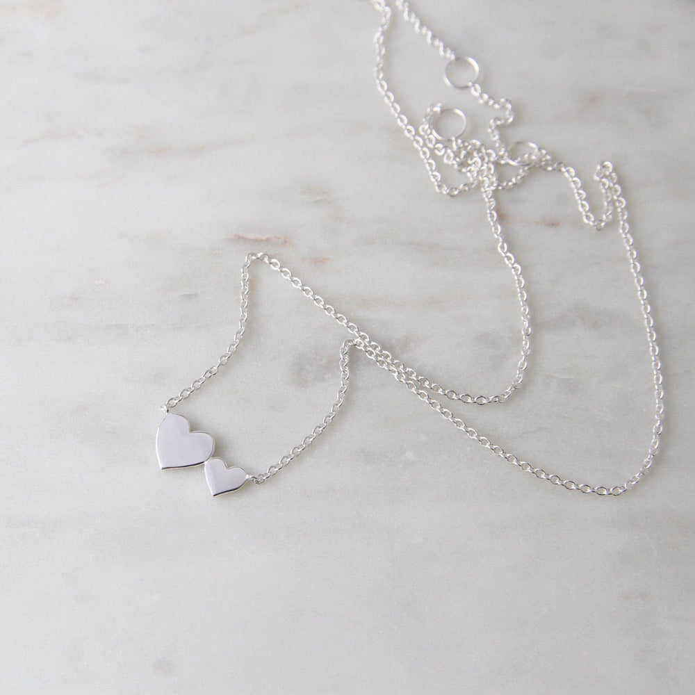 
                      
                        NKL Sterling Silver Big & Little Hearts Necklace
                      
                    