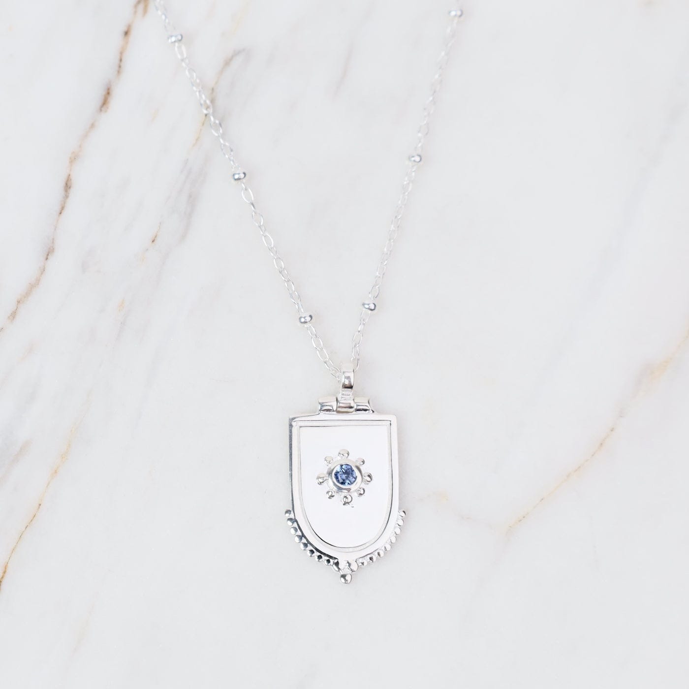 NKL Sterling Silver Dotted Shield Necklace With Blue Sapphire