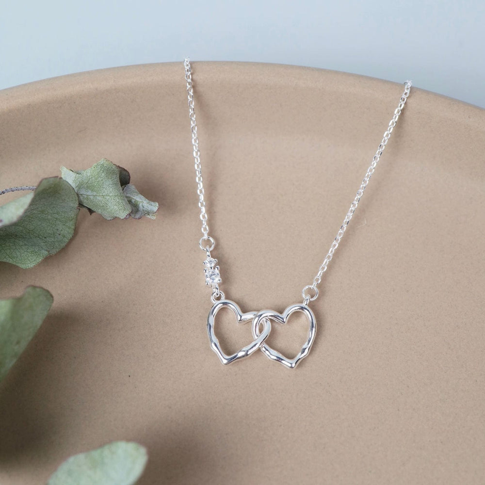 
                  
                    NKL Sterling Silver Interlocking Hearts Necklace
                  
                