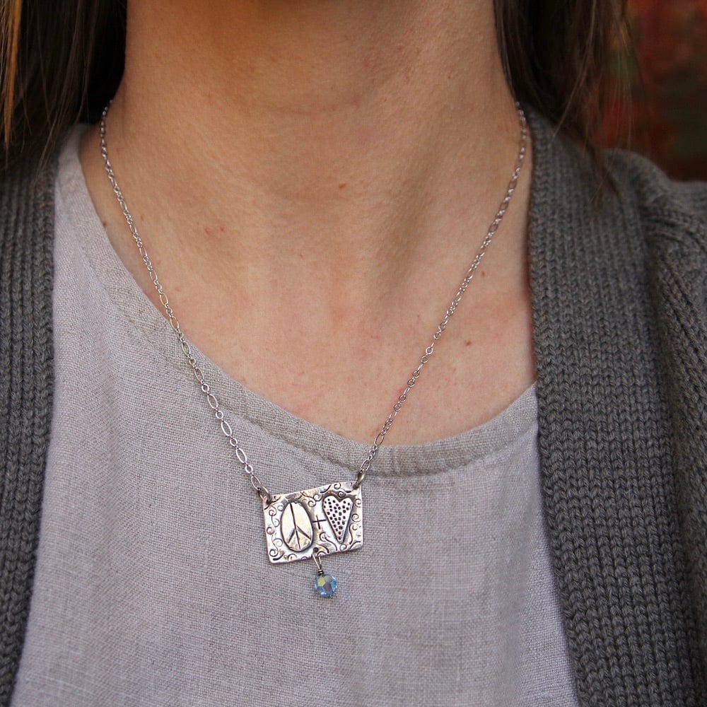 
                      
                        NKL Sterling Silver Peace and Love Necklace
                      
                    