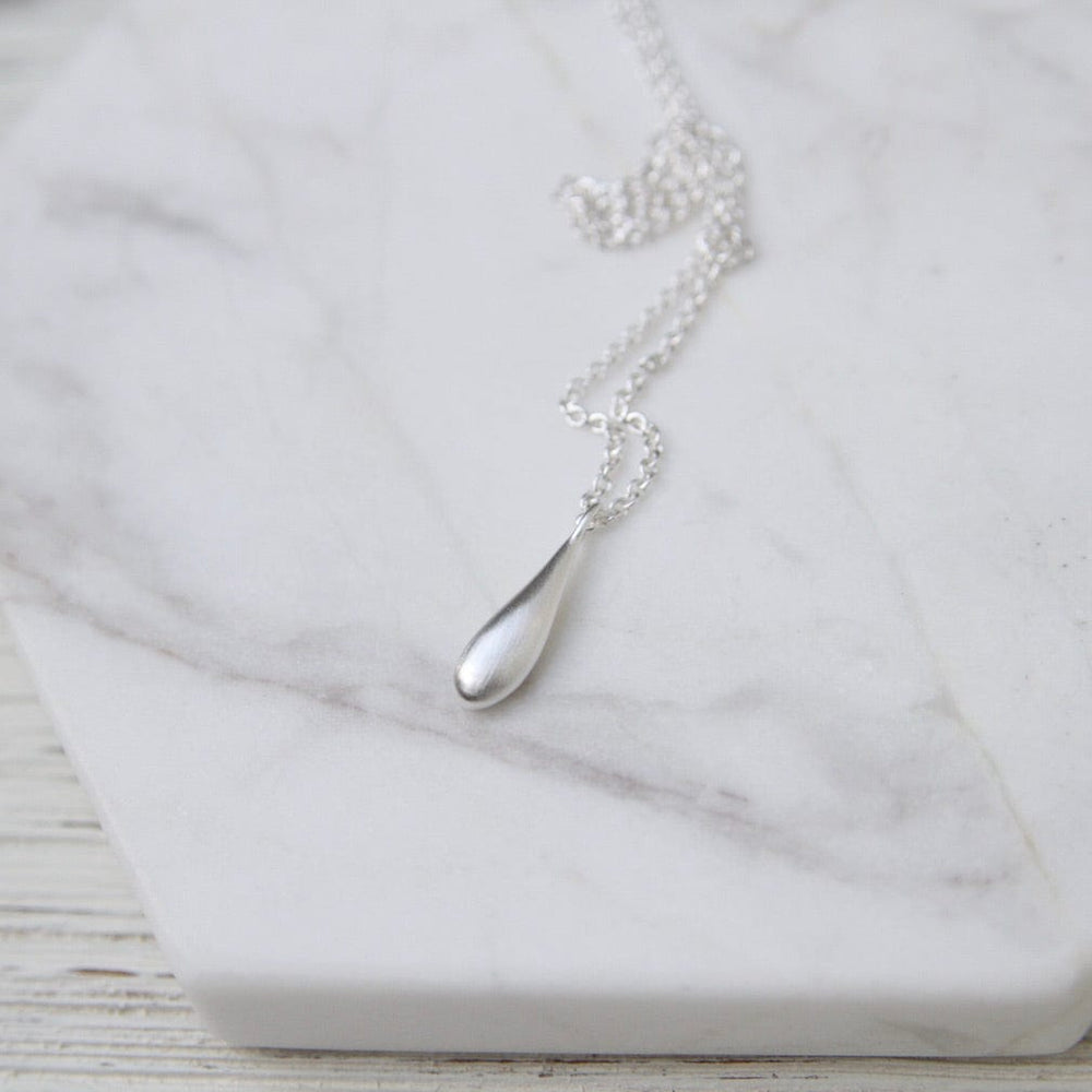 
                      
                        NKL Sterling Silver Small Elongated Dew Drop Necklace
                      
                    