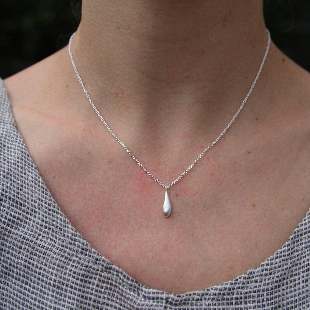 
                      
                        NKL Sterling Silver Small Elongated Dew Drop Necklace
                      
                    