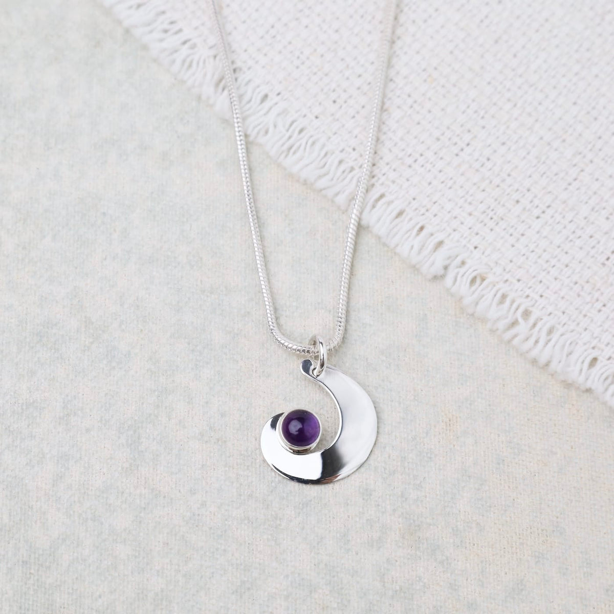 NKL Swirl Pendant With Amethyst Cabachon