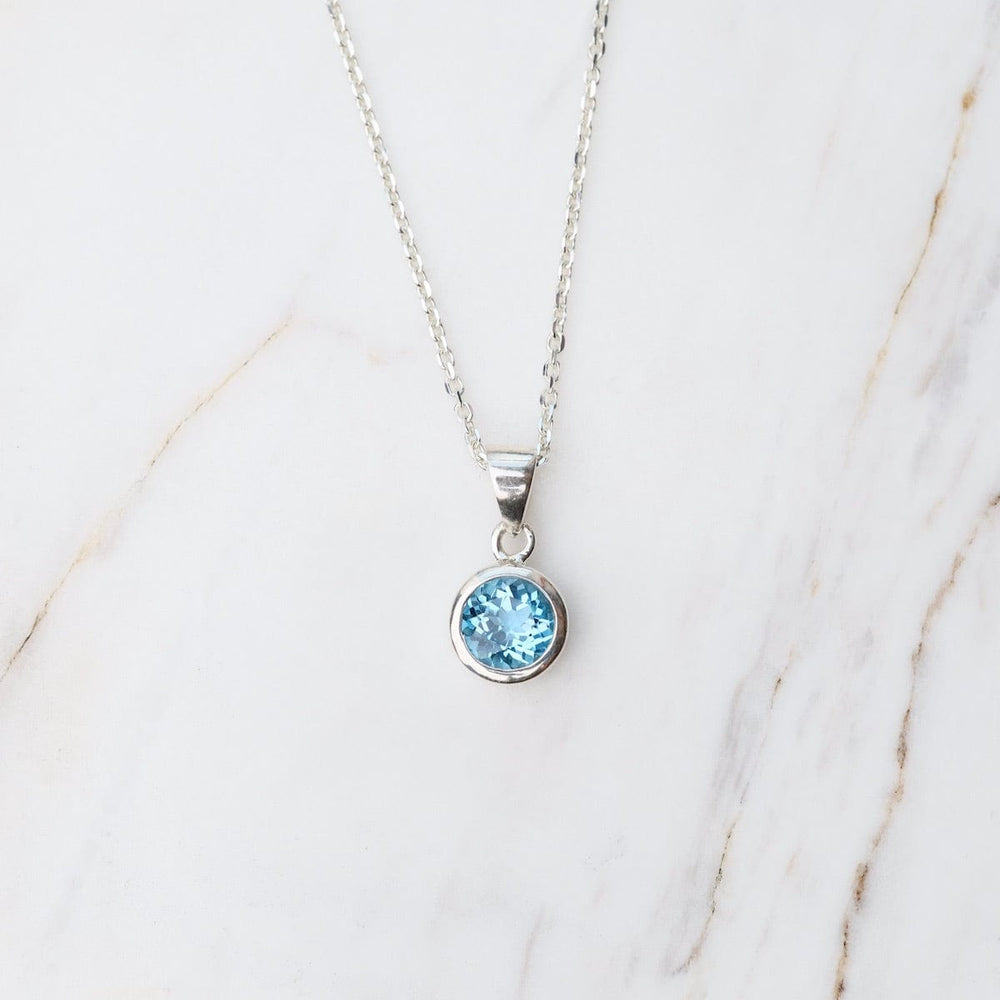 
                      
                        NKL Swiss Blue Topaz Dot Pendant
                      
                    