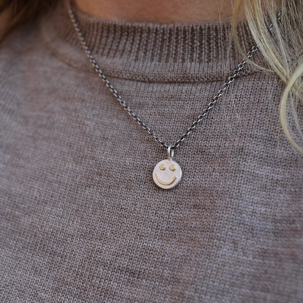 
                      
                        NKL Tiny Happy Face Necklace in Sterling Silver
                      
                    