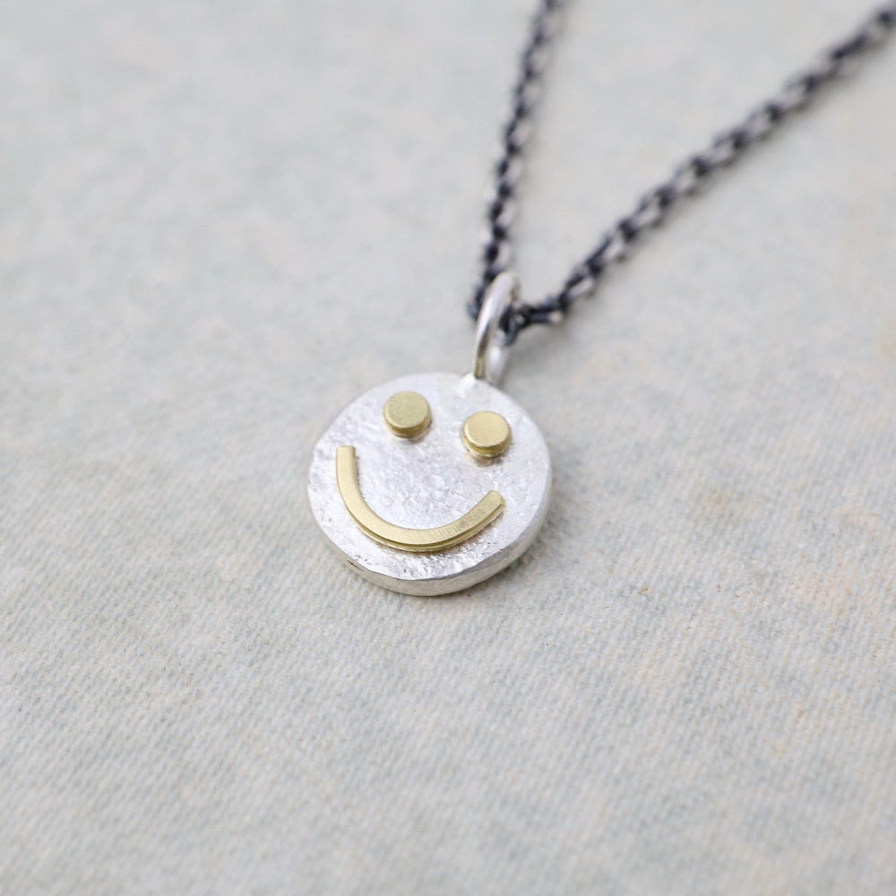 
                      
                        NKL Tiny Happy Face Necklace in Sterling Silver
                      
                    