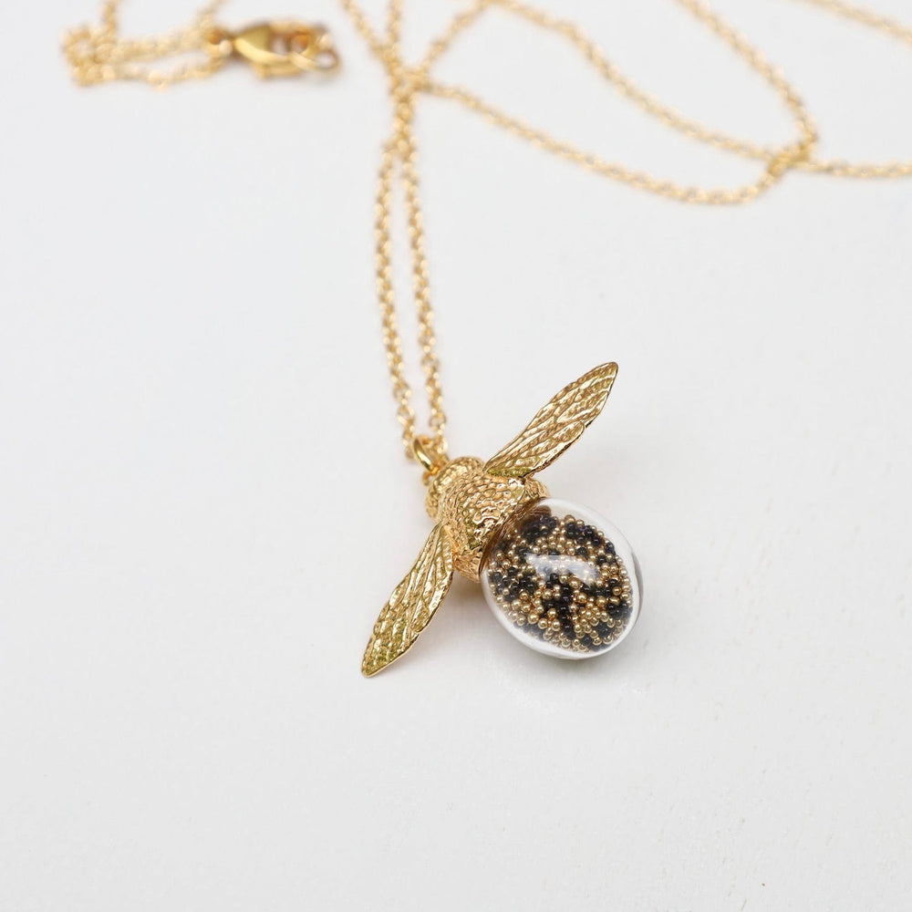 
                  
                    NKL-VRM Bee Shaker Necklace - Black & Gold Microbeads
                  
                