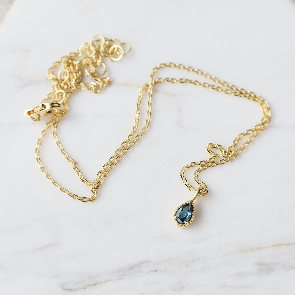 
                  
                    NKL-VRM Gold Vermeil Pear Cut London Blue Topaz with Milgrain Edge Necklace
                  
                