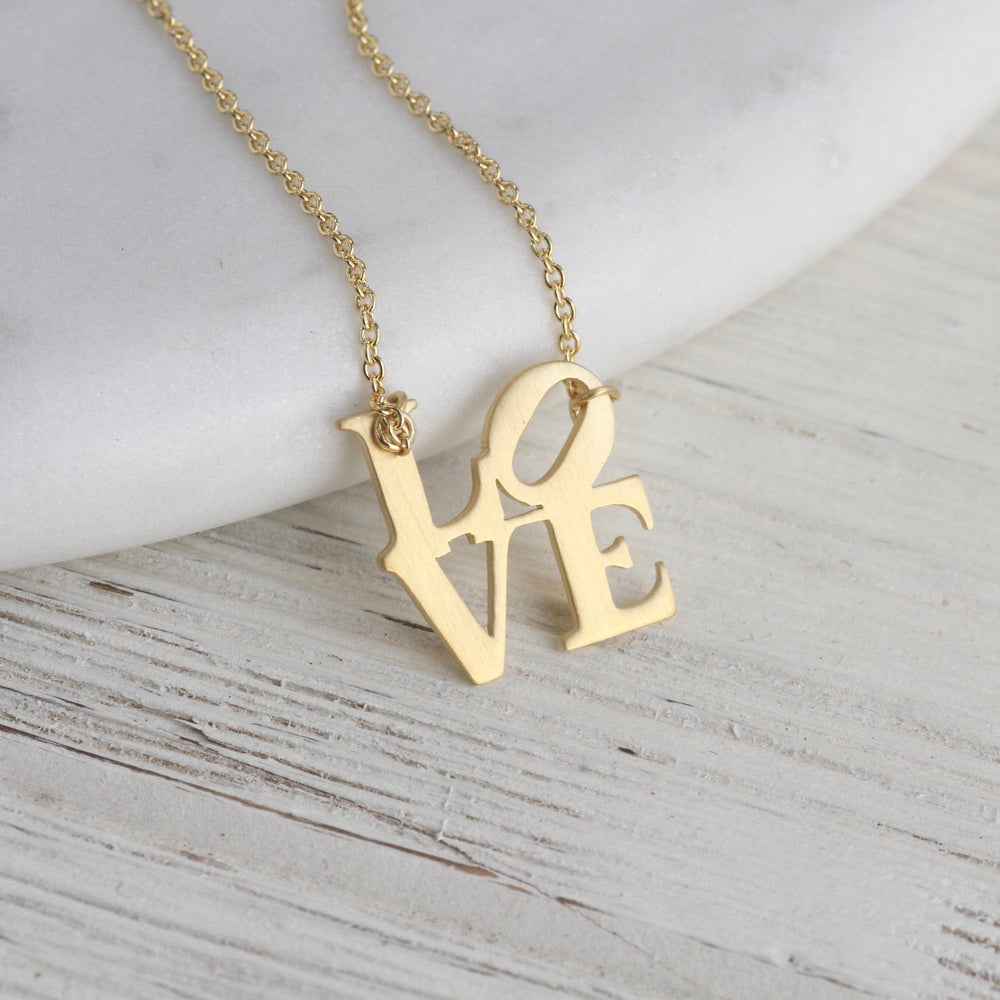 
                  
                    NKL-VRM Matte Gold Vermeil LOVE Sculpture Necklace
                  
                