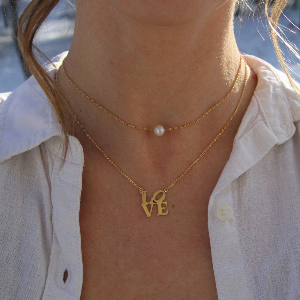 
                      
                        NKL-VRM Matte Gold Vermeil LOVE Sculpture Necklace
                      
                    