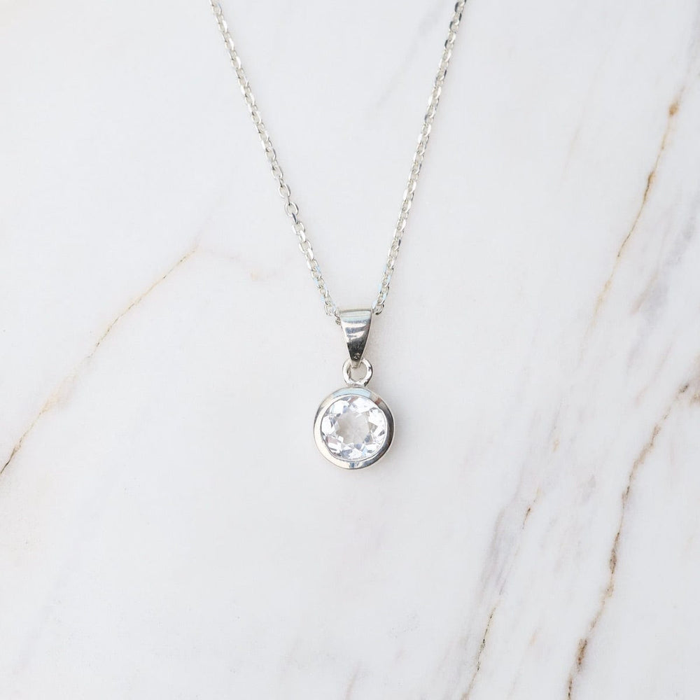 
                      
                        NKL White Topaz Dot Pendant
                      
                    