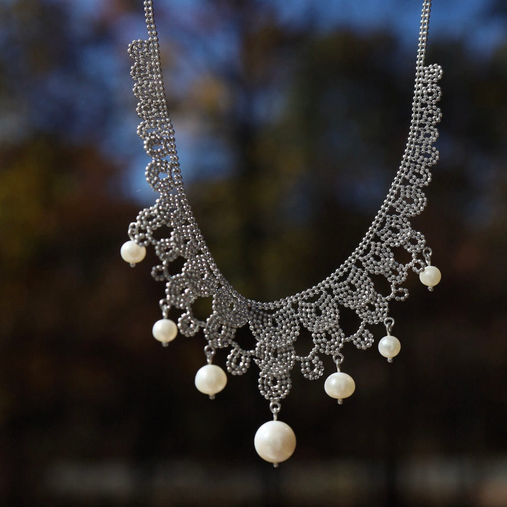 
                  
                    NKL Woven Sterling Silver Seven Pearl Lace Draped Necklace
                  
                