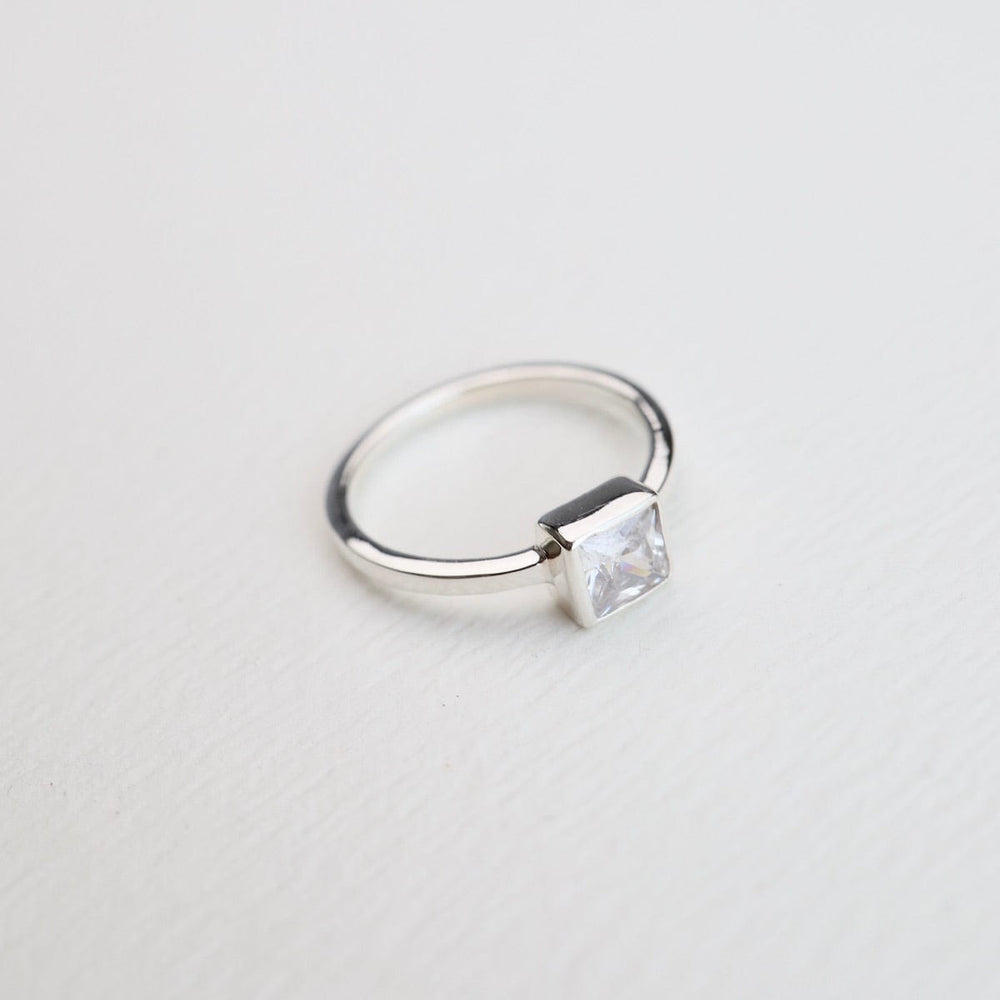 
                      
                        RNG Bezel Set Square CZ Silver Ring
                      
                    