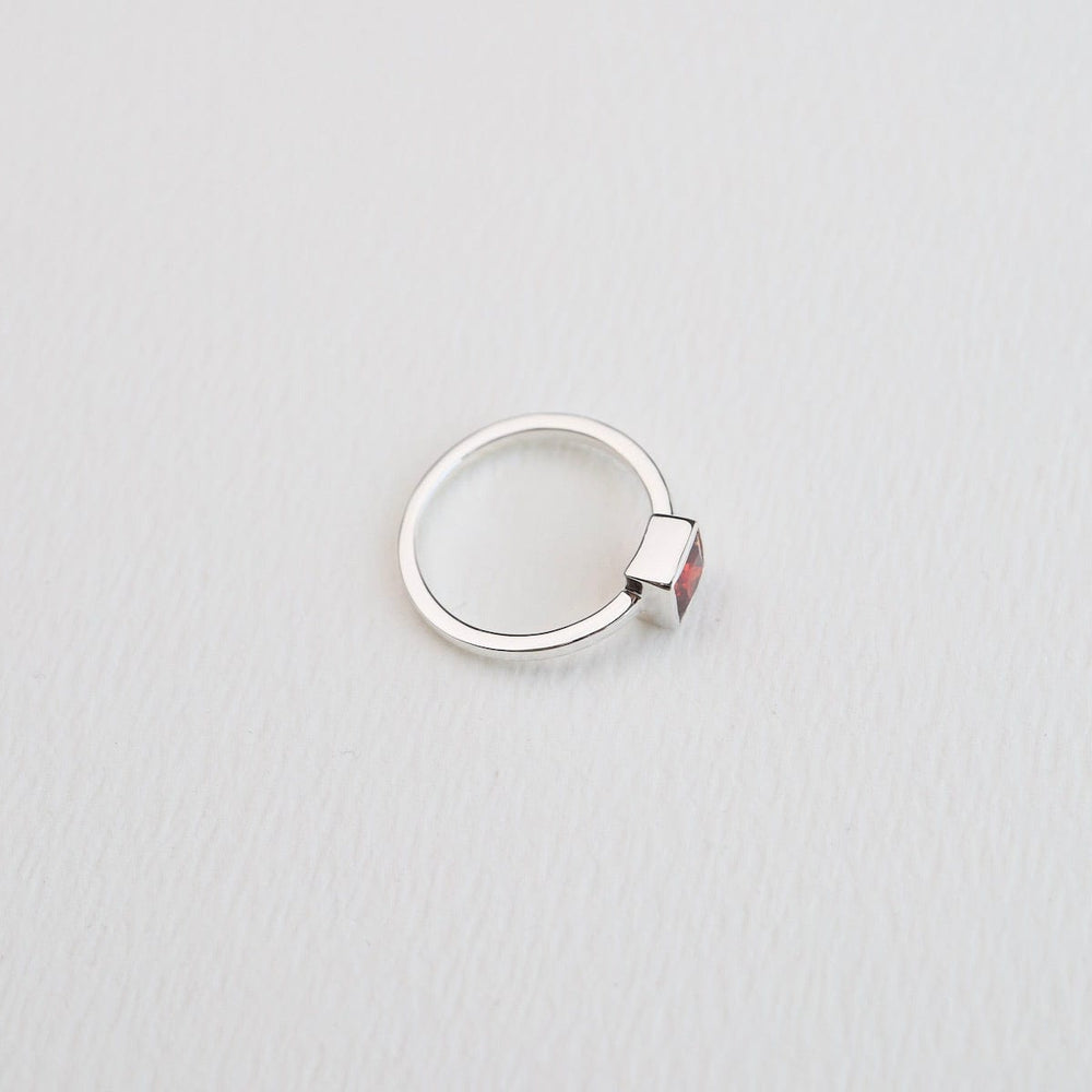 
                      
                        RNG Bezel Set Square Red CZ Silver Ring
                      
                    