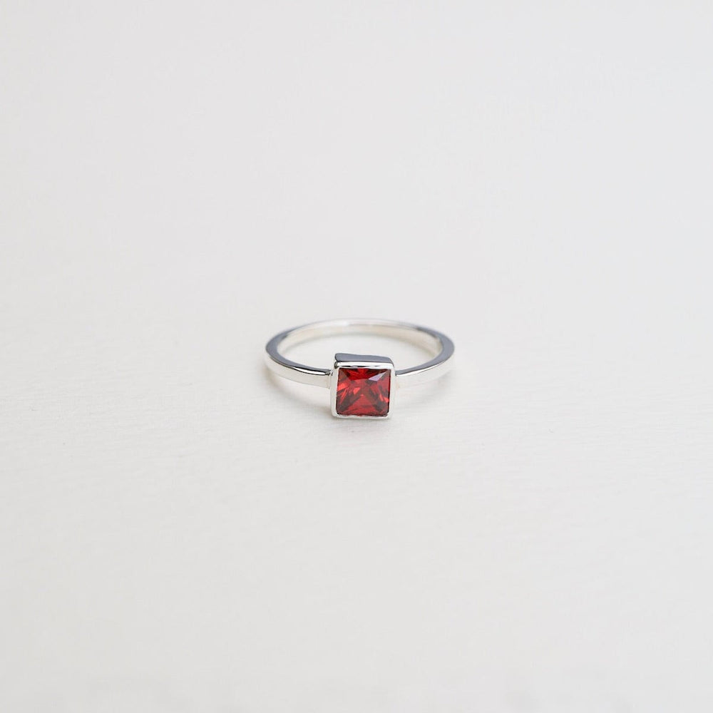 
                      
                        RNG Bezel Set Square Red CZ Silver Ring
                      
                    