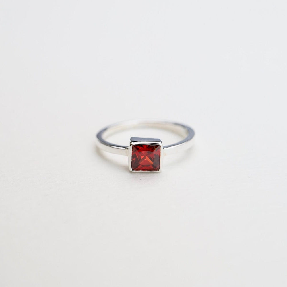 
                      
                        RNG Bezel Set Square Red CZ Silver Ring
                      
                    