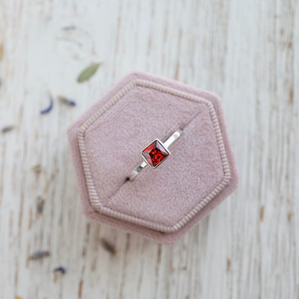 
                      
                        RNG Bezel Set Square Red CZ Silver Ring
                      
                    