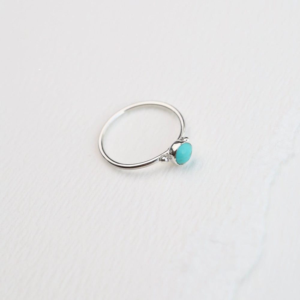 
                  
                    RNG Delicate Compressed Turquoise Round Silver Ring
                  
                