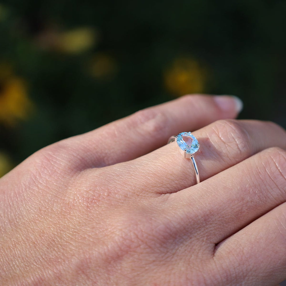 
                      
                        RNG East West Prong Set Oval Sky Blue Topaz Ring
                      
                    