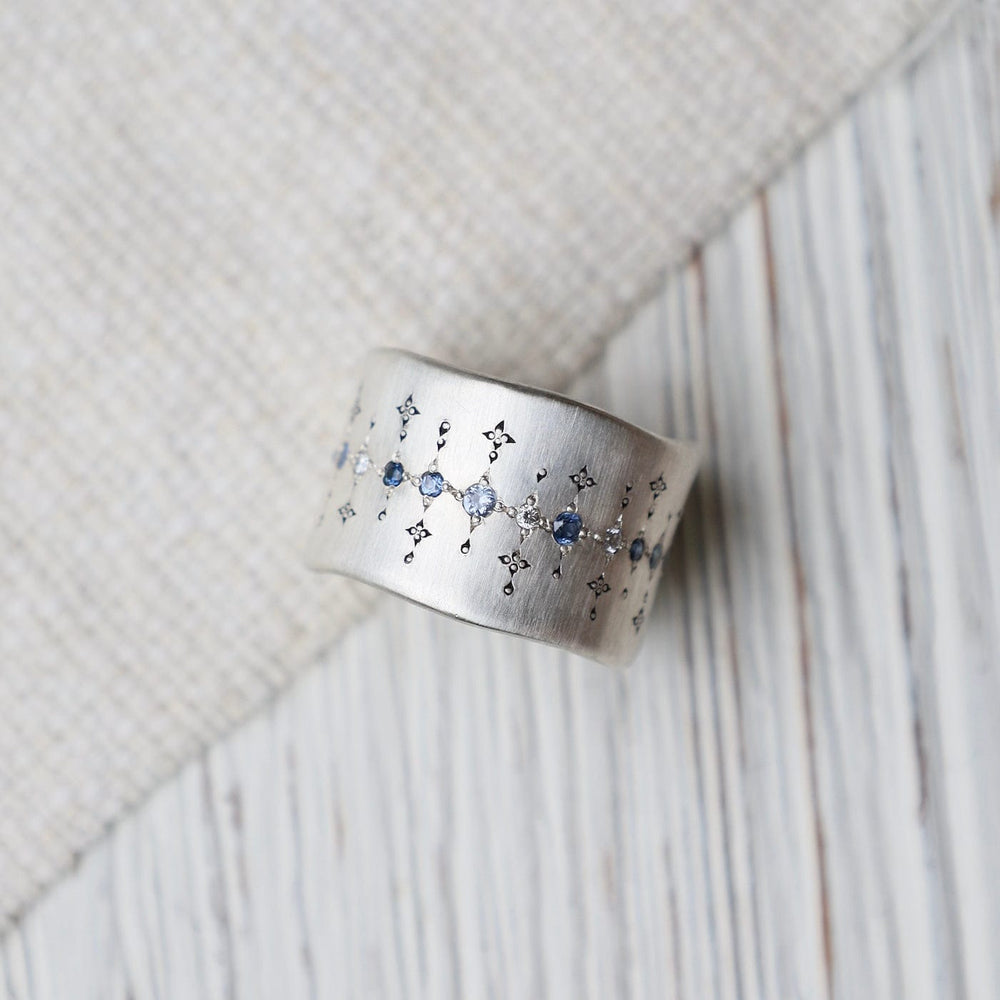 
                      
                        RNG Single Organic Wide Band in Sapphire, Aquamarine & Diamond
                      
                    