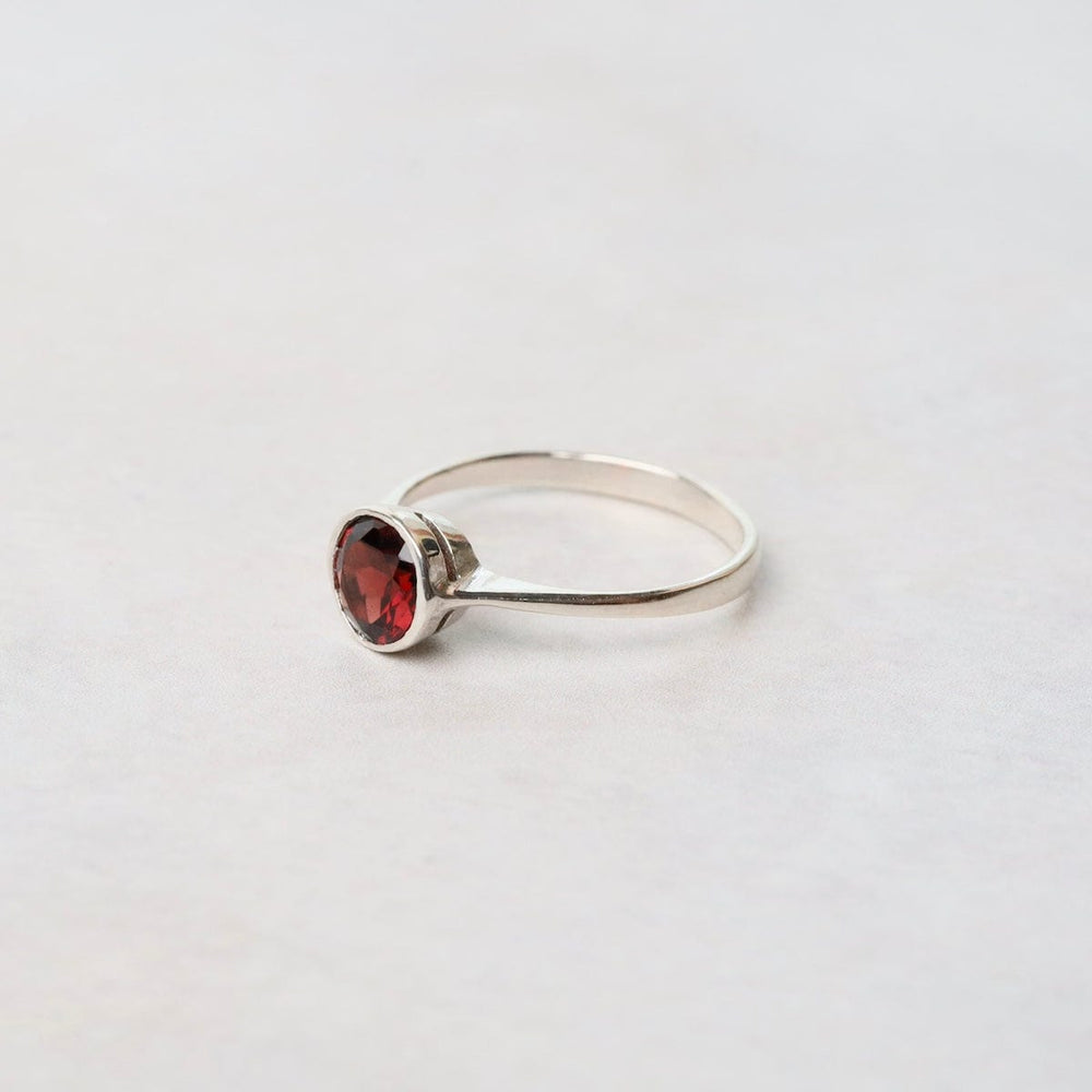 
                      
                        RNG Sterling Silver Ring with 6mm Round Bezel Set African Garnet
                      
                    