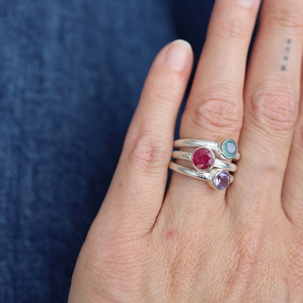 
                      
                        RNG Sterling Silver Ruby Triple Stone Ring
                      
                    