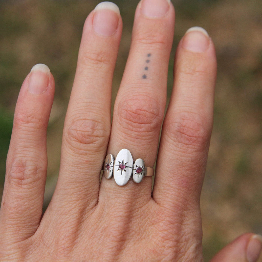 
                      
                        RNG Three Ovals with Star Set Red Garnet Ring
                      
                    